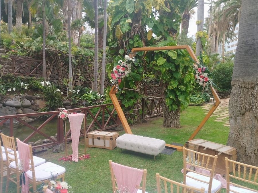 Arco hexagonal de ceremonia decorado con flores